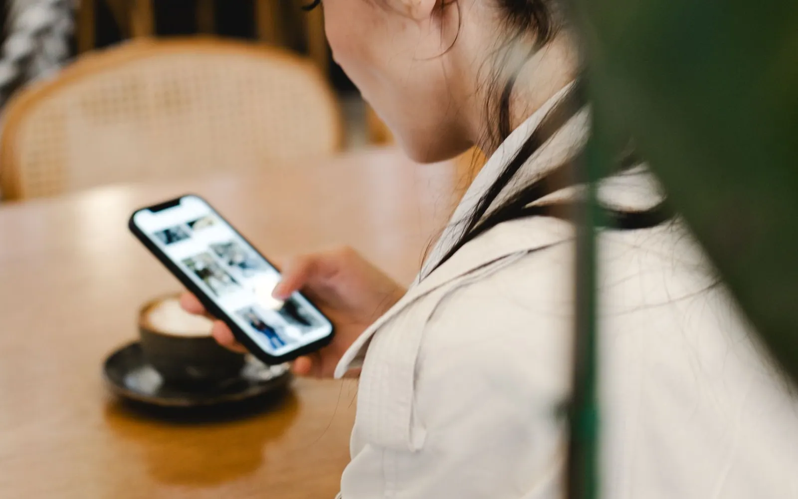 Café owner checking the current counter menu on a phone