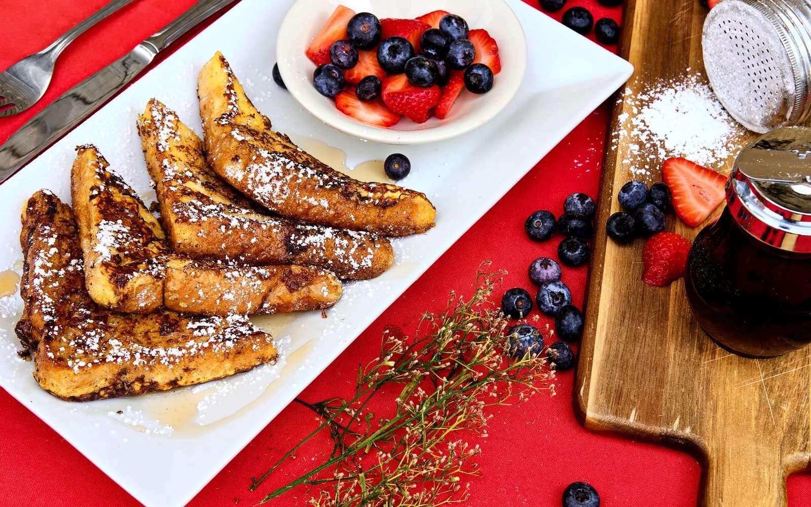 French toast with berries beside a clear digital menu description
